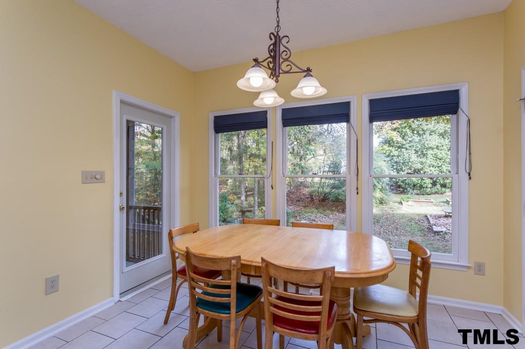 1241 Hillingdon Way Raleigh, NC 27614 - Photo 7 of 21 Kitchen and Breakfast Room boast brand new roman shades. Access to the Screened Porch from the Breakfast Room.