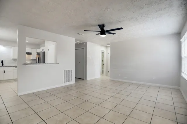 a view of a kitchen with a sink and a window
