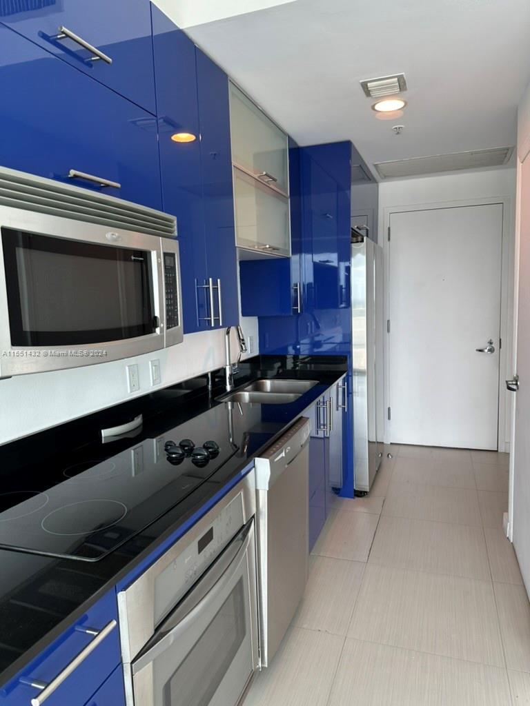 a kitchen with stainless steel appliances a stove microwave and cabinets