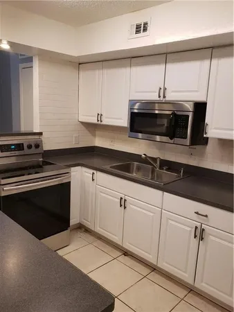 a kitchen with a stove and a microwave