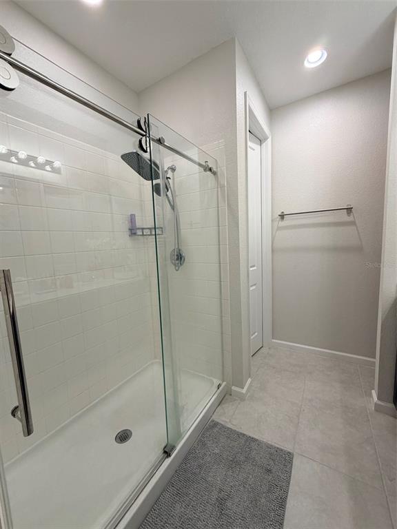 5684 Western Sun Drive St. Cloud, FL 34771 - Photo 12 of 16 a bathroom with a shower and a glass door