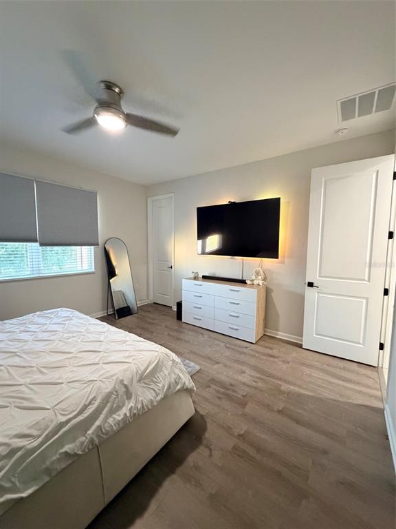 5684 Western Sun Drive St. Cloud, FL 34771 - Photo 13 of 16 a bedroom with a bed and a flat screen tv