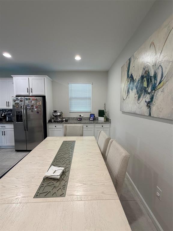 5684 Western Sun Drive St. Cloud, FL 34771 - Photo 5 of 16 a large kitchen with kitchen island a counter top space a sink stainless steel appliances and cabinets
