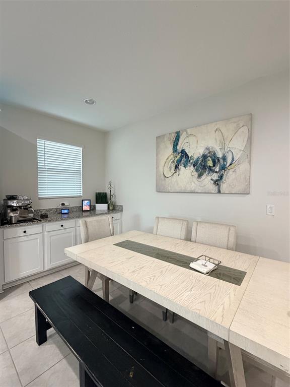 5684 Western Sun Drive St. Cloud, FL 34771 - Photo 6 of 16 a room with a table chairs and white appliances