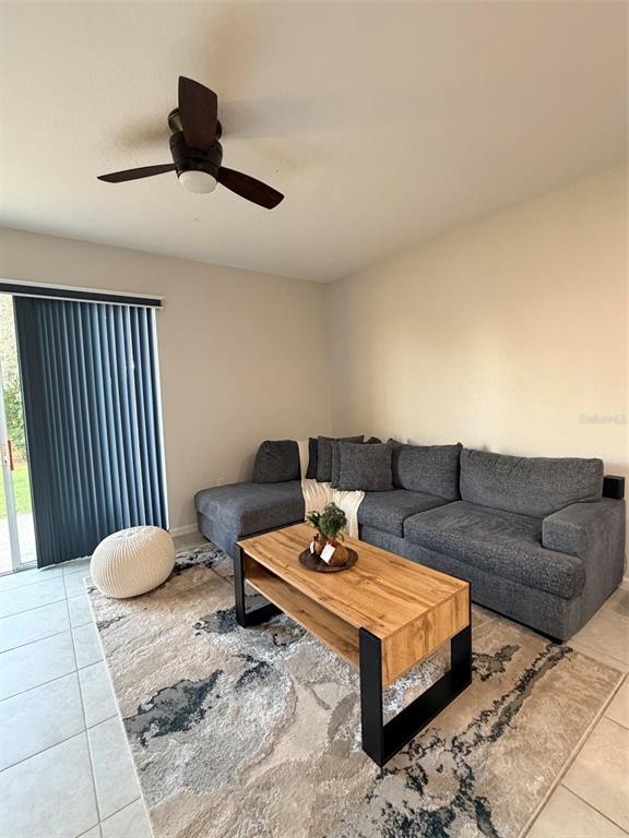 5684 Western Sun Drive St. Cloud, FL 34771 - Photo 7 of 16 a living room with furniture and a rug