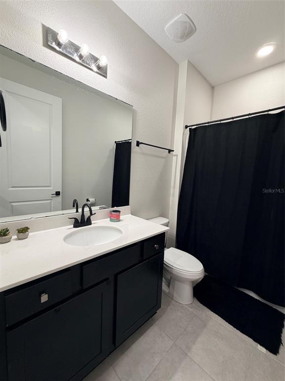 5684 Western Sun Drive St. Cloud, FL 34771 - Photo 9 of 16 a bathroom with a sink and a mirror