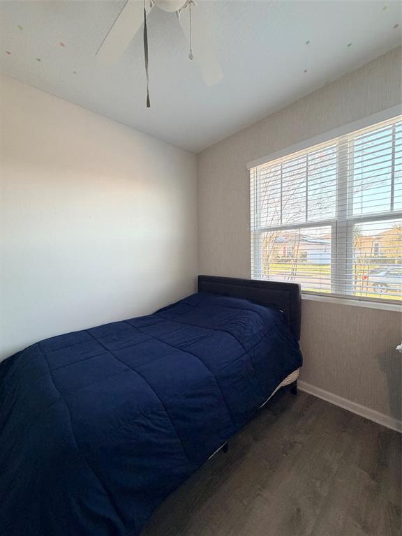 5684 Western Sun Drive St. Cloud, FL 34771 - Photo 10 of 16 a bed sitting in a room next to a window