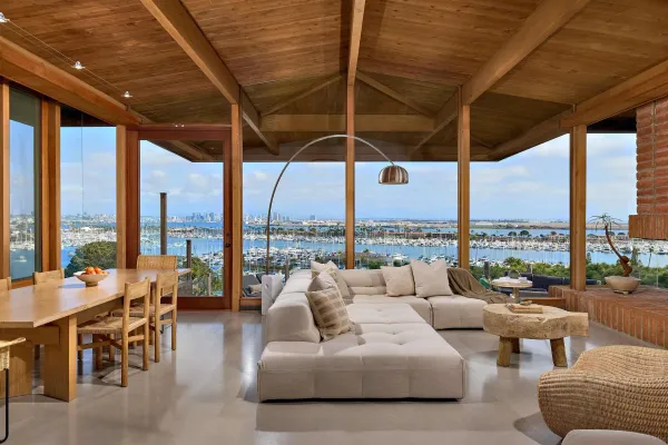 a living room with furniture and floor to ceiling windows