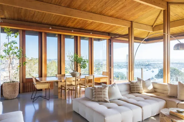 a living room with furniture and floor to ceiling windows