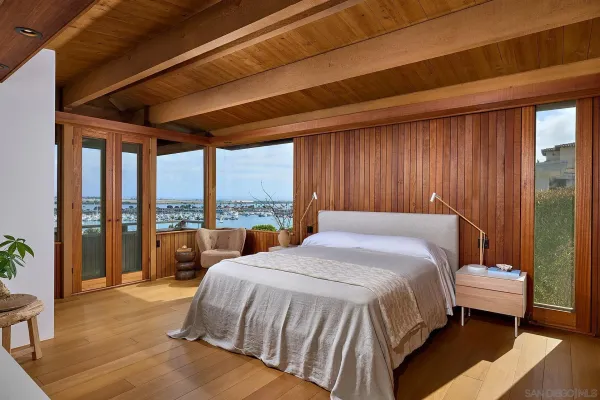 a bedroom with a bed and a large window