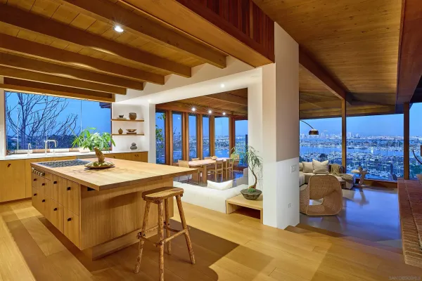 a kitchen with a stove a refrigerator and wooden floor