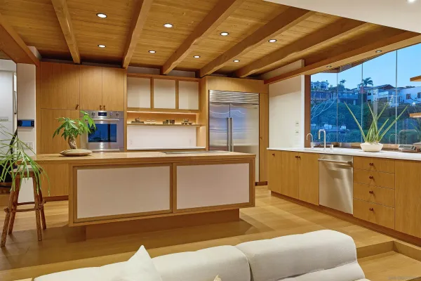 a kitchen with stainless steel appliances granite countertop a sink a stove and a refrigerator