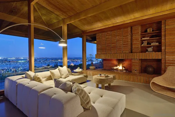 a view of a patio with couches chairs under an umbrella