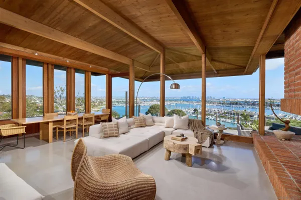 a living room with furniture and floor to ceiling windows