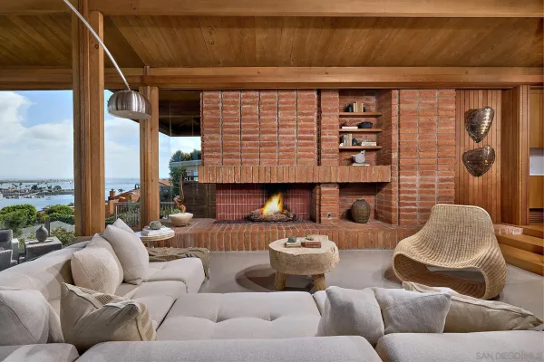 a living room with furniture and a floor to ceiling window