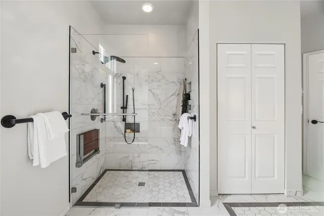 a bathroom with a granite countertop shower a mirror and a sink