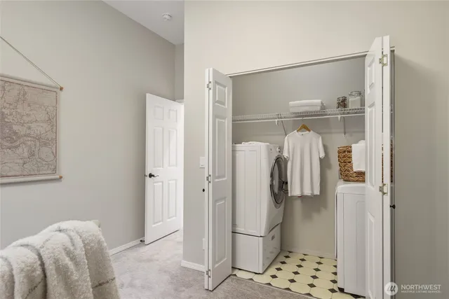 a walk in closet with wooden floor and a bathroom view