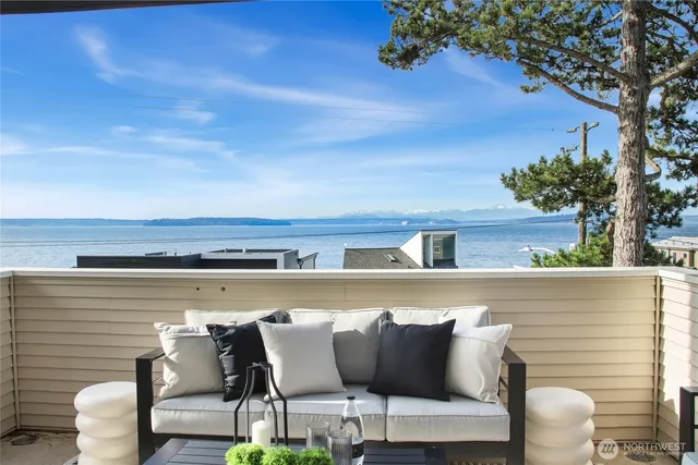 a balcony with furniture and a potted plant