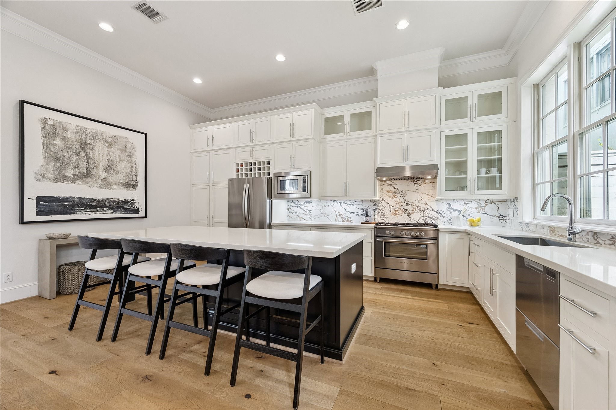 6108 Nicholas Grove Place Houston, TX 77055 - Photo 4 of 29 Gorgeous kitchen with Fisher & Paykel stainless steel appliances has upgraded porcelain slab backsplash, stacked cabinets, with undermount lighting.