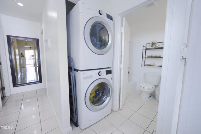 a utility room with sink dryer and washer