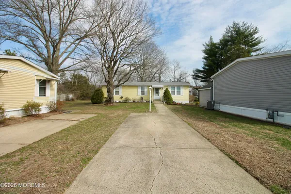 a view of a yard with a house and a tree