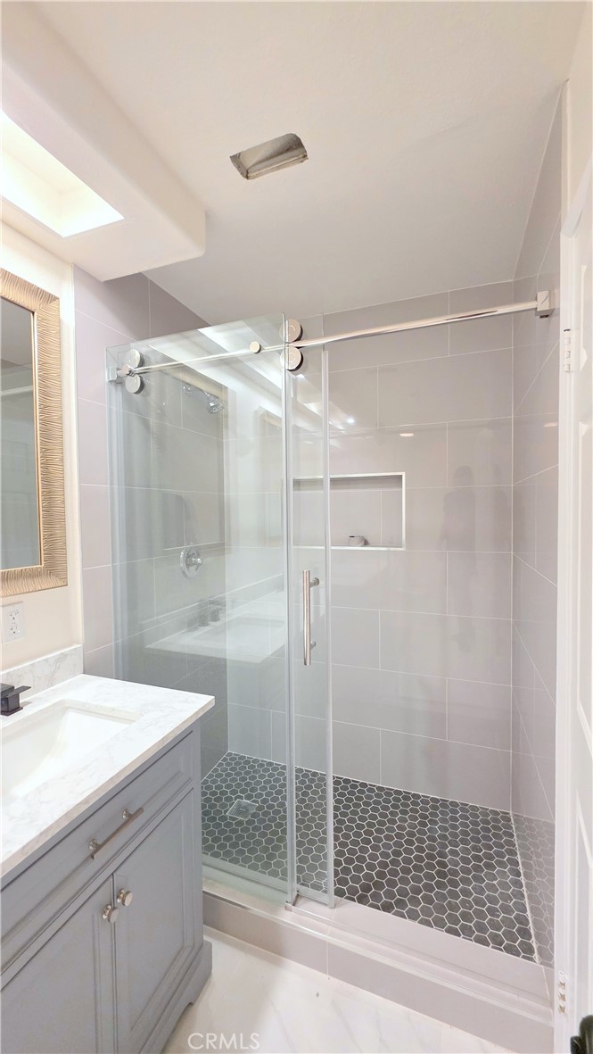 1116 Cloverdale Street Riverside, CA 92501 - Photo 15 of 29 a bathroom with a shower sink and mirror