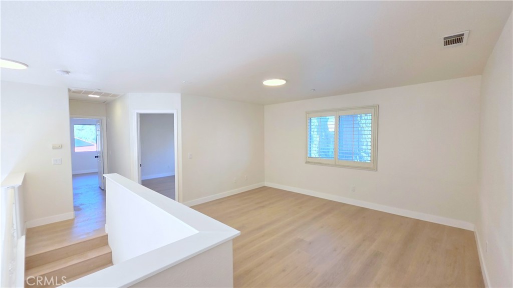 1116 Cloverdale Street Riverside, CA 92501 - Photo 17 of 29 an empty room with wooden floor and windows