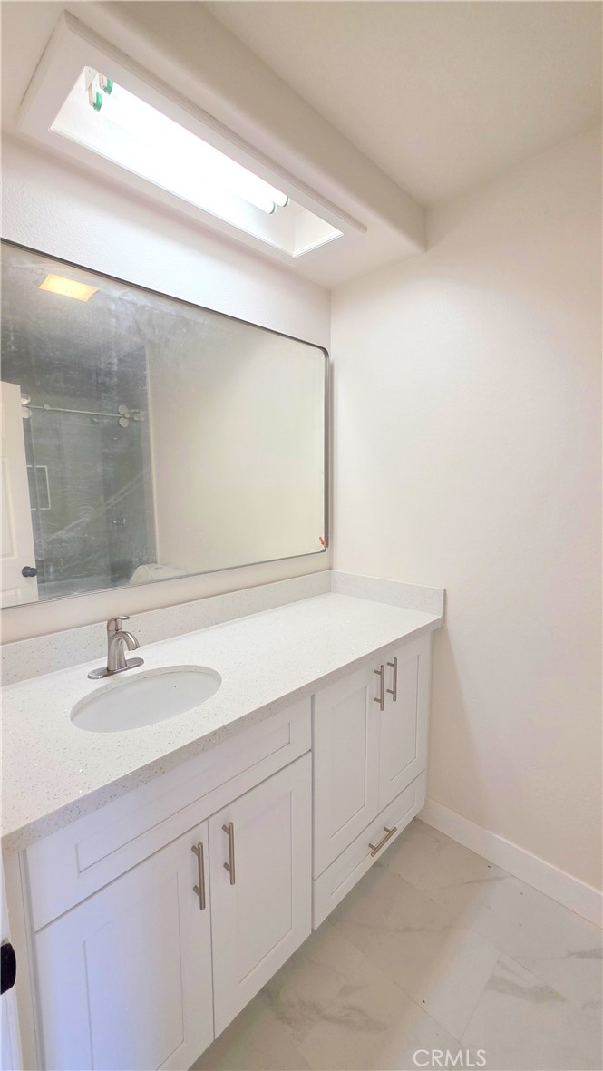 1116 Cloverdale Street Riverside, CA 92501 - Photo 23 of 29 a bathroom with a sink and a mirror
