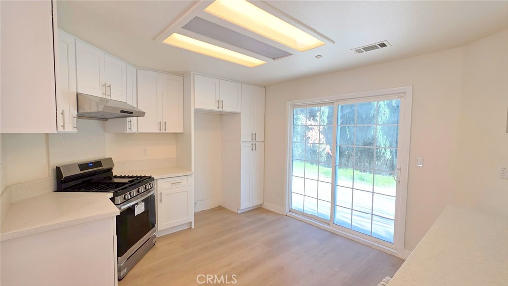 1116 Cloverdale Street Riverside, CA 92501 - Photo 7 of 29 a kitchen with stainless steel appliances granite countertop a stove a sink and a refrigerator