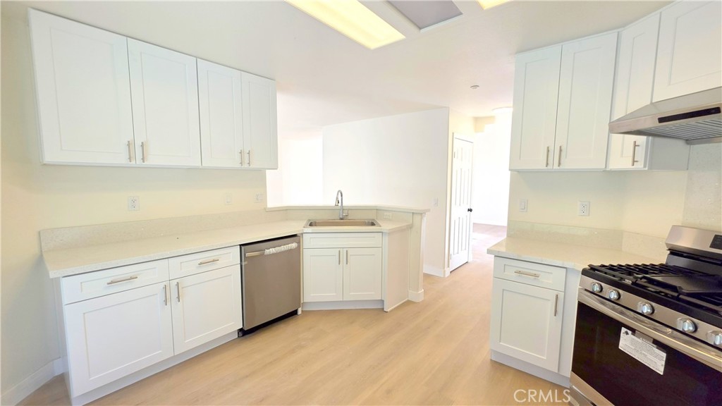 1116 Cloverdale Street Riverside, CA 92501 - Photo 9 of 29 a kitchen with white cabinets and white appliances