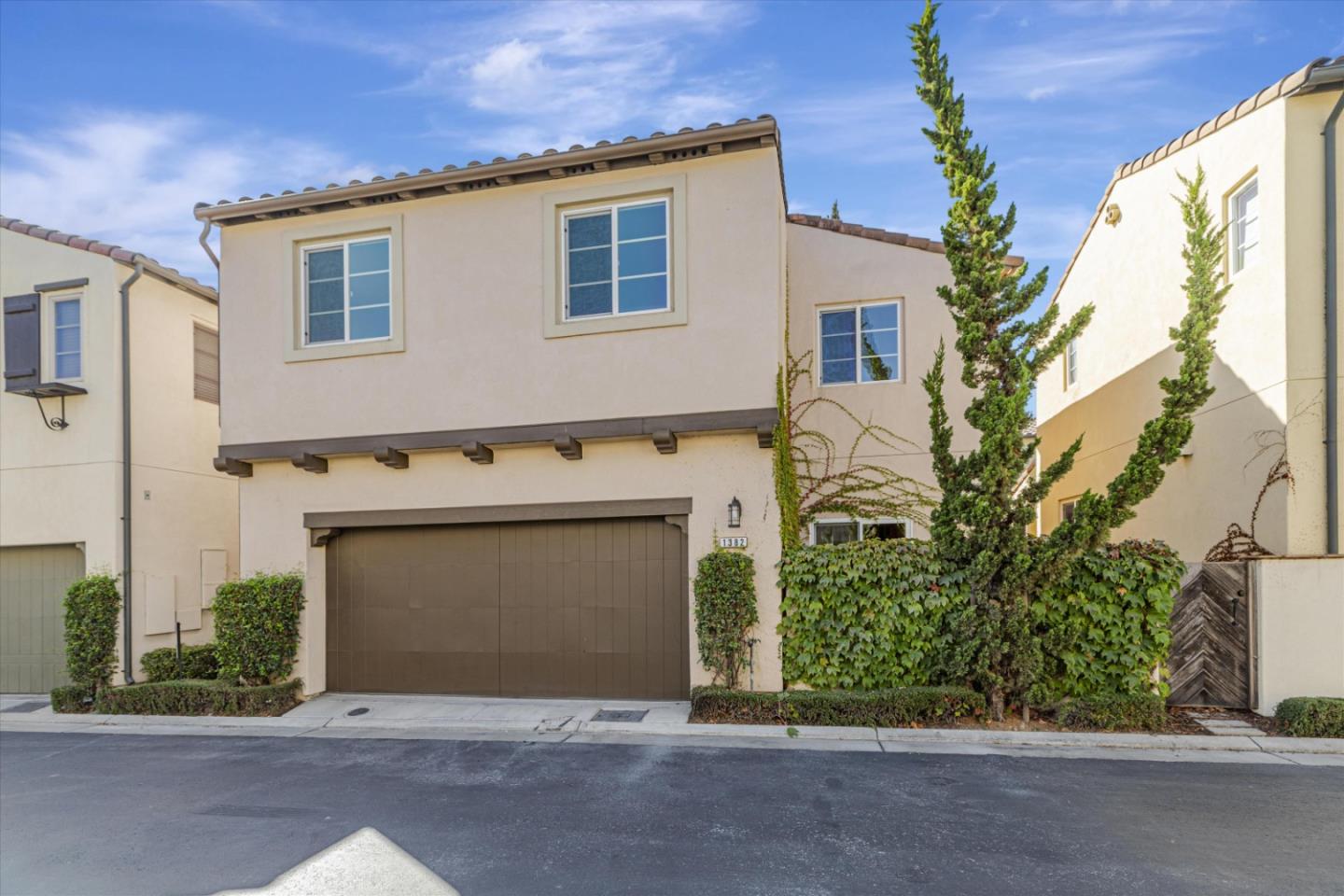 1382 Dahlia Loop San Jose, CA 95126 - Photo 24 of 31 a front view of a house with a yard and garage