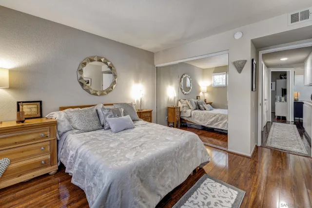 a bedroom with bed and a chandelier