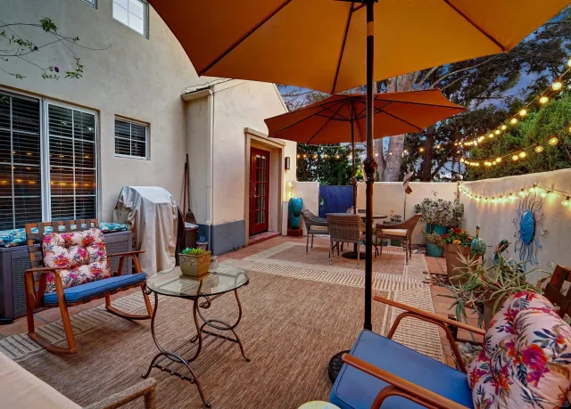 a view of a tables and chairs under an umbrella in patio