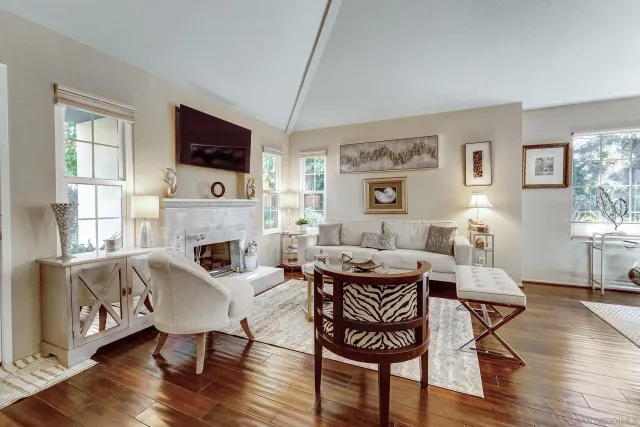 a living room with furniture a fireplace and a flat screen tv