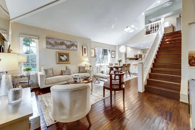 a living room with furniture and a wooden floor