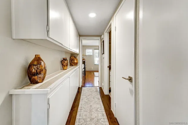 a view of hallway with wooden floor