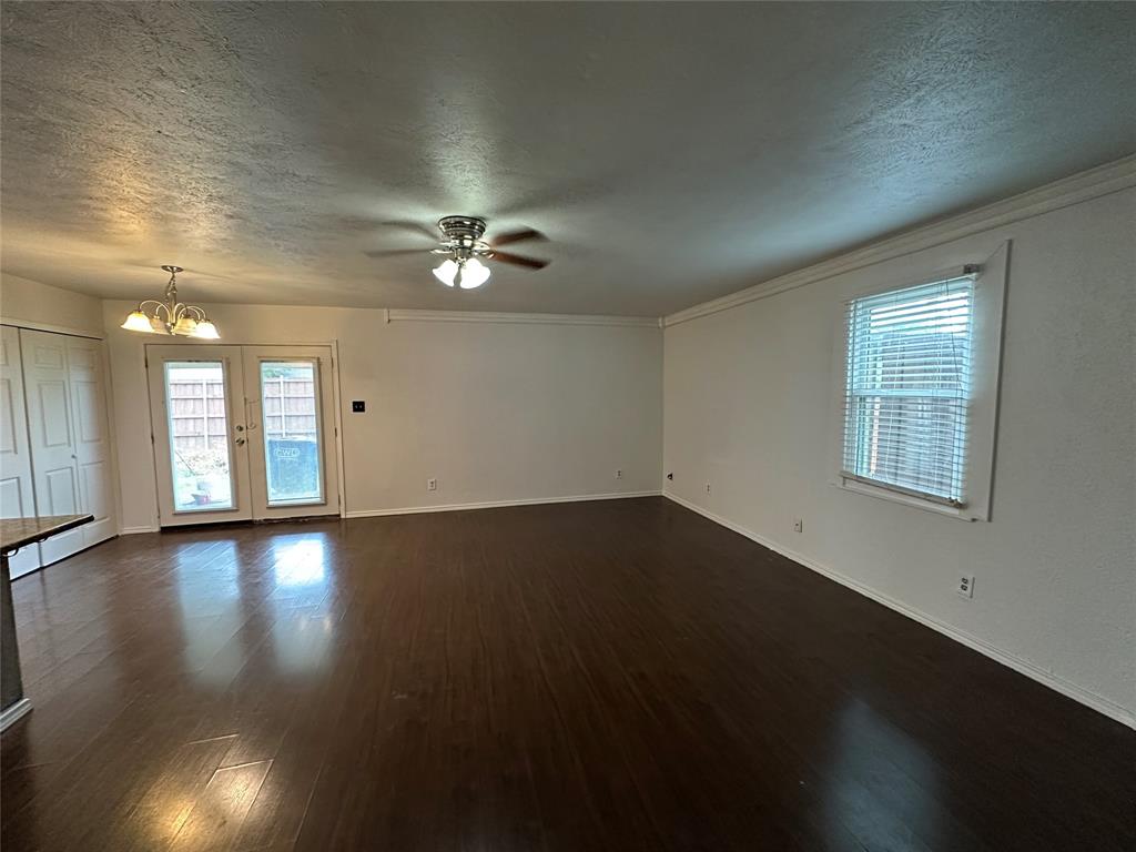 910 Sunny Slope Drive Allen, TX 75002 - Photo 1 of 27 a view of an empty room with wooden floor and a window