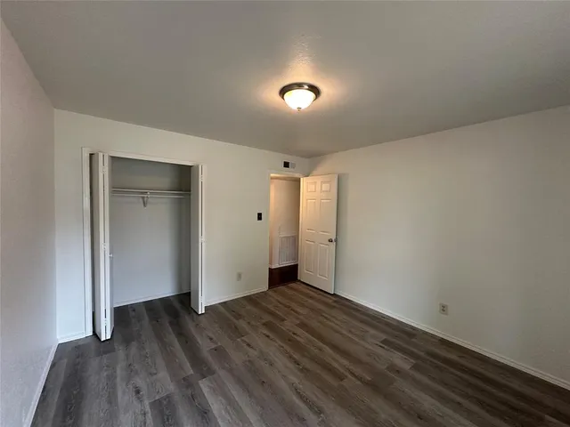 a view of hallway with wooden floor