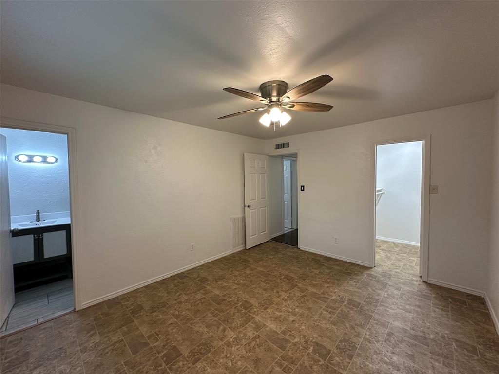 910 Sunny Slope Drive Allen, TX 75002 - Photo 17 of 27 an empty room with a chandelier fan and a chandelier fan