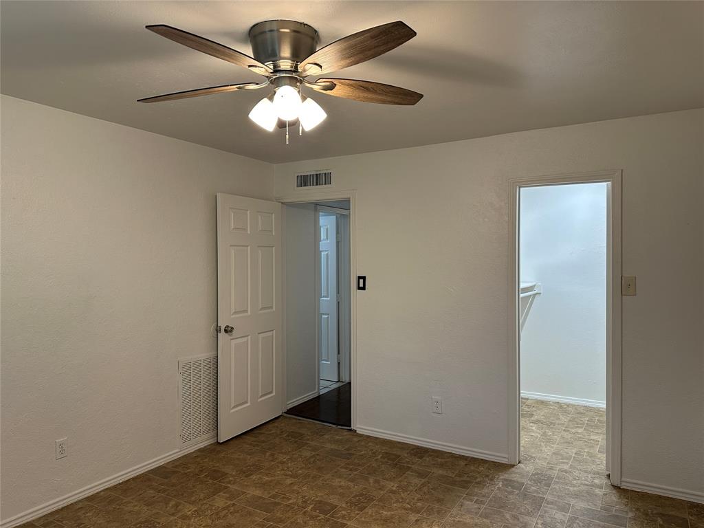 910 Sunny Slope Drive Allen, TX 75002 - Photo 18 of 27 an empty room with a chandelier fan and a ceiling fan