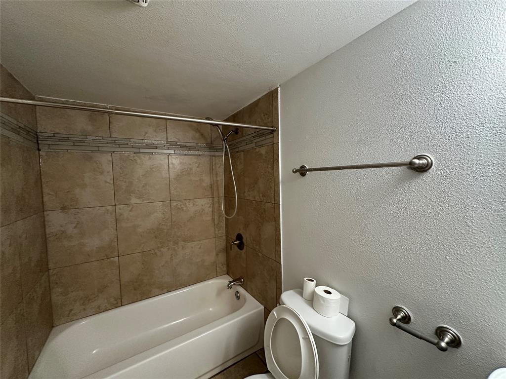 910 Sunny Slope Drive Allen, TX 75002 - Photo 23 of 27 a bathroom with a shower a toilet and a sink