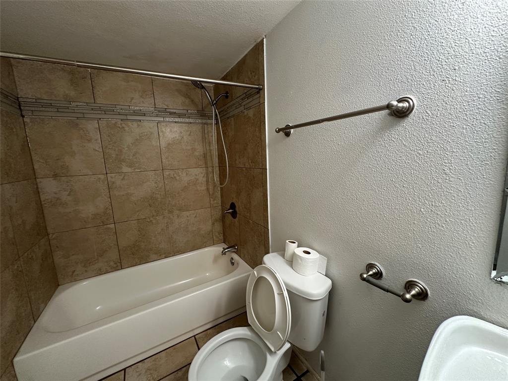 910 Sunny Slope Drive Allen, TX 75002 - Photo 24 of 27 a bathroom with a tub a toilet and a shower