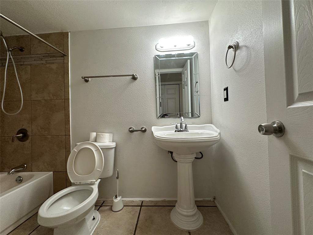 910 Sunny Slope Drive Allen, TX 75002 - Photo 25 of 27 a bathroom with a toilet sink shower and mirror