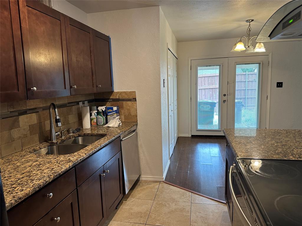 910 Sunny Slope Drive Allen, TX 75002 - Photo 7 of 27 a kitchen with granite countertop cabinets and window