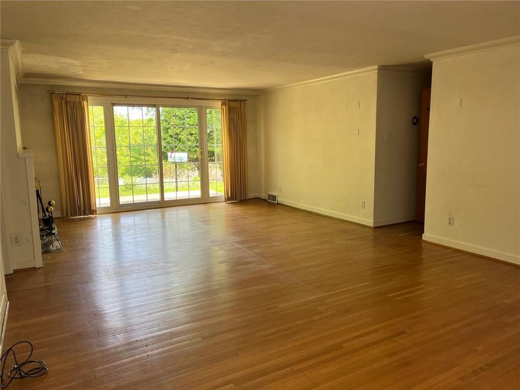 148 Easley Road Pittsburgh, PA 15237 - Photo 3 of 23 a view of an empty room with wooden floor and a window