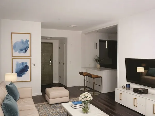a living room with furniture and wooden floor