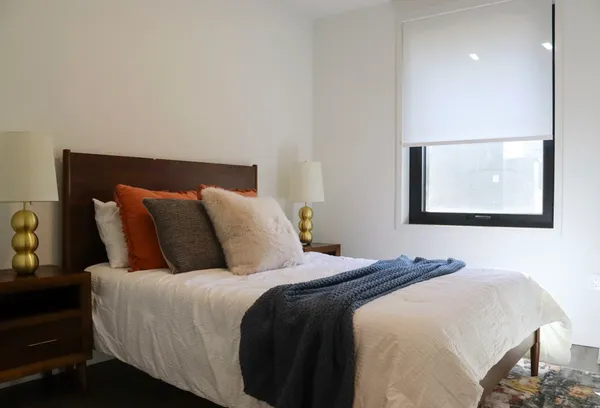 a bedroom with a bed and a painting on the wall