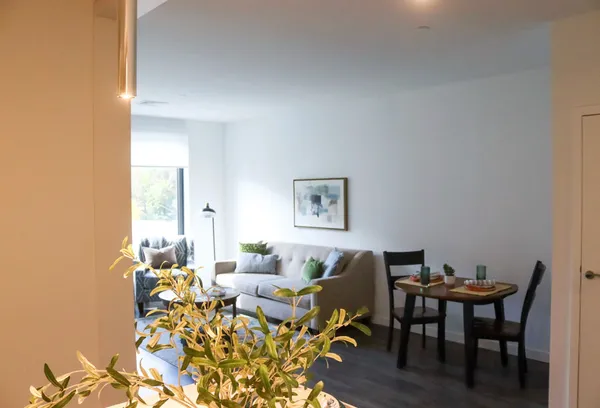 a living room with furniture wooden floor and a table
