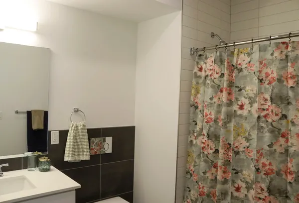 a bathroom with a shower curtain and a sink