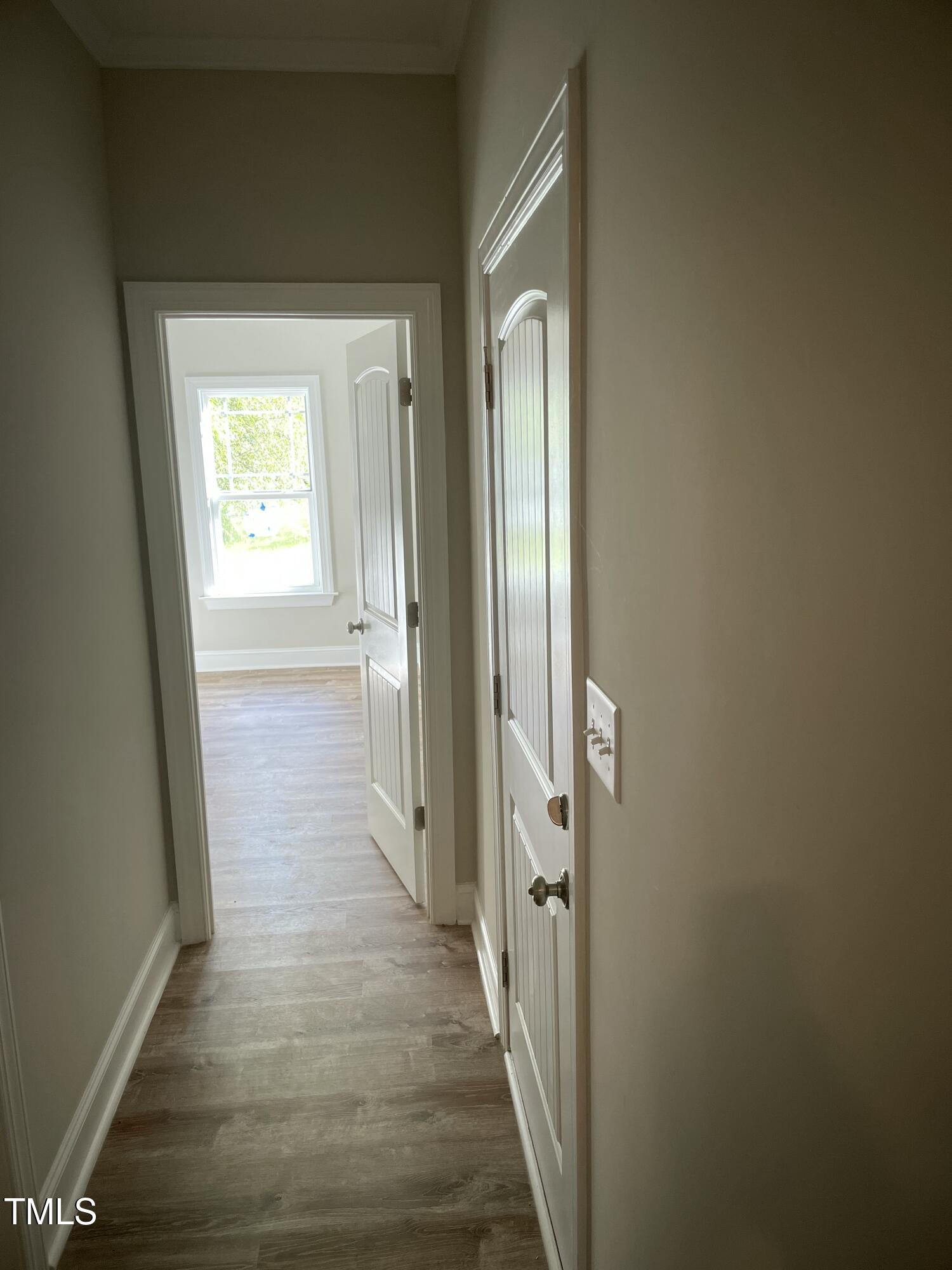 5500 Batoul Lane Raleigh, NC 27606 - Photo 11 of 32 a view of a hallway with wooden floor and a bathroom